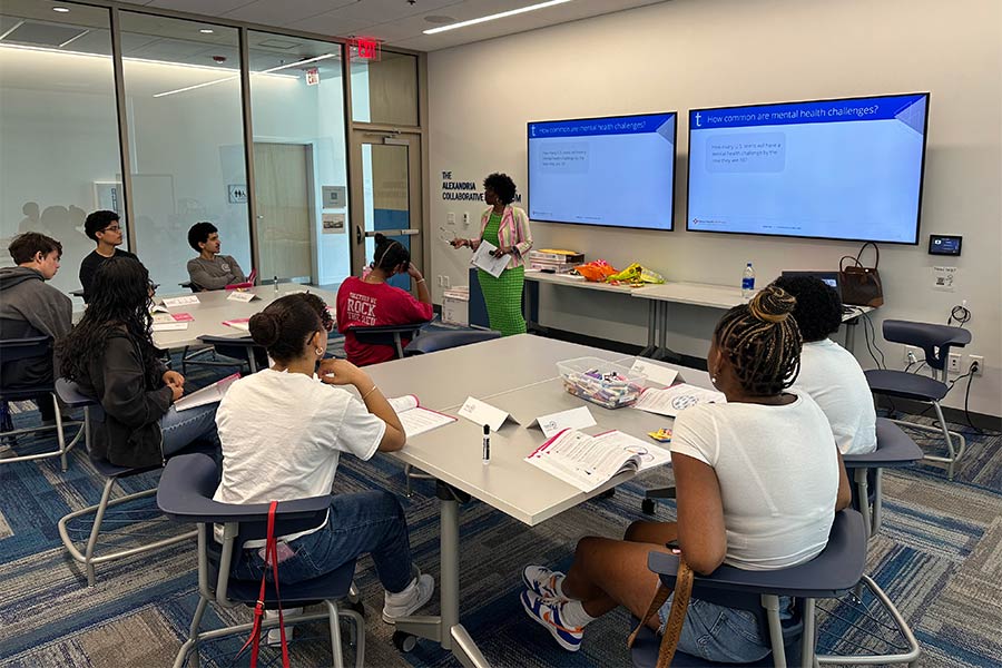 Photo of a woman teaching children in class