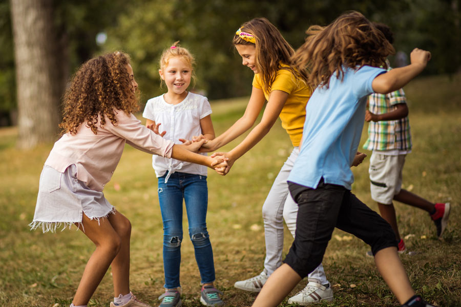 Photo of happy children playing outside