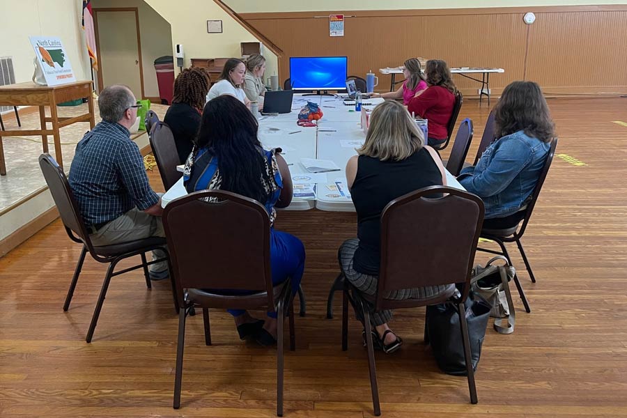 Photo of people around a table at the Bertie Behavioral Health Network
